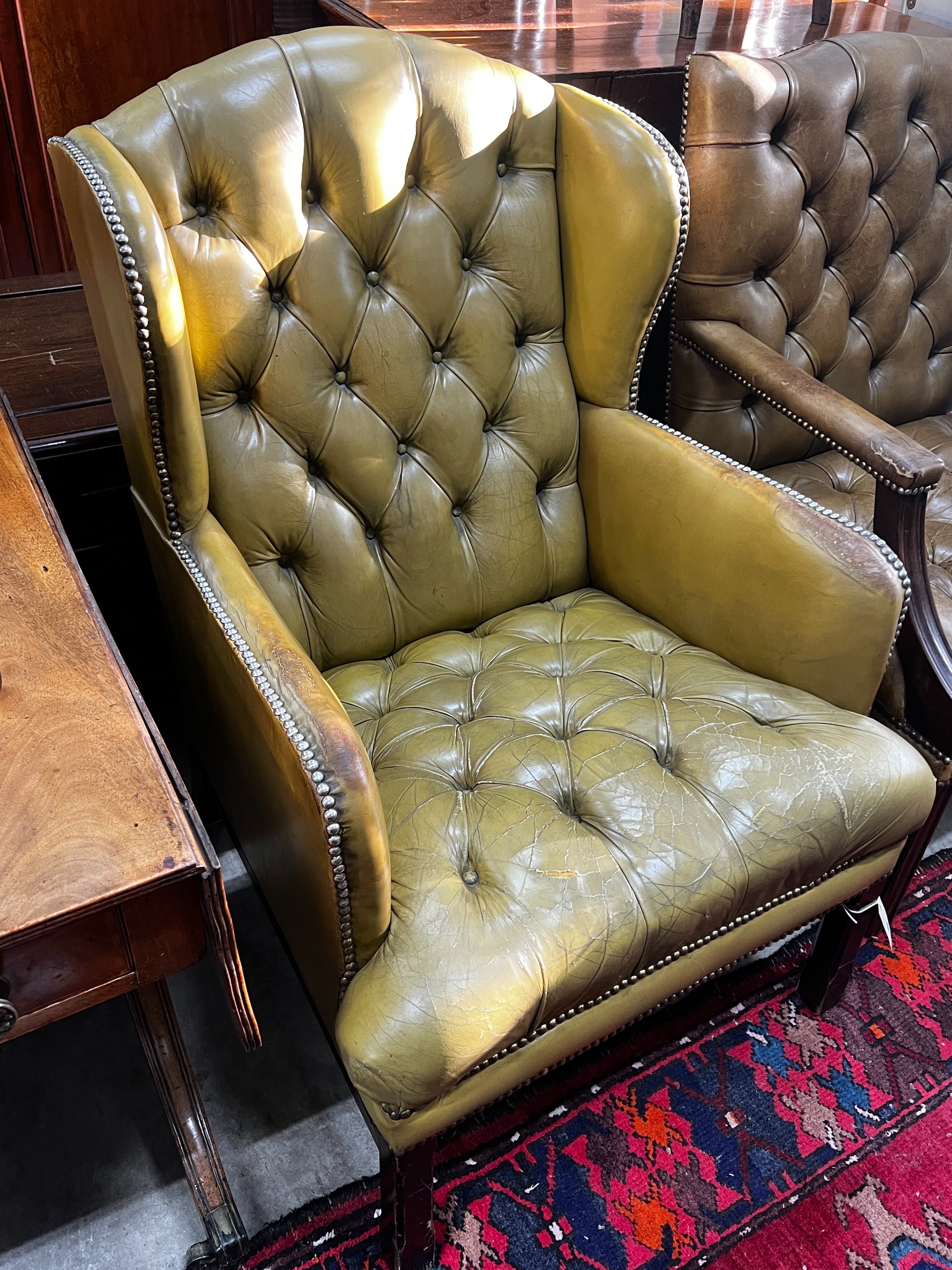 A George III style button green leather armchair, width 65cm, depth 68cm, height 98cm